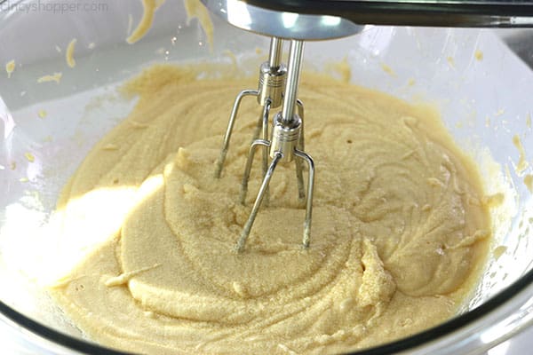 Mixing banana cake ingredients in a bowl.