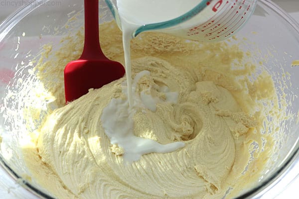 Adding milk mixture to banana cake ingredients.