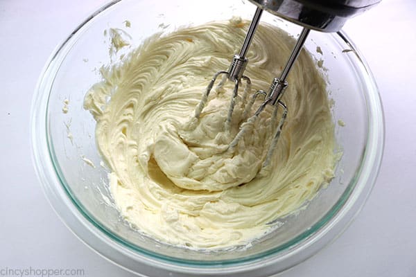 Mixing cream cheese for cheesecake bars.
