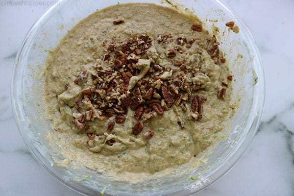 Adding optional nuts to zucchini bread mixture.