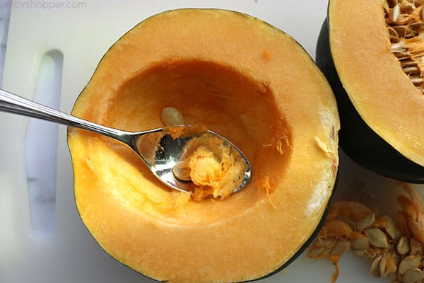How to make acorn squash. Removing flesh and seeds with spoon.