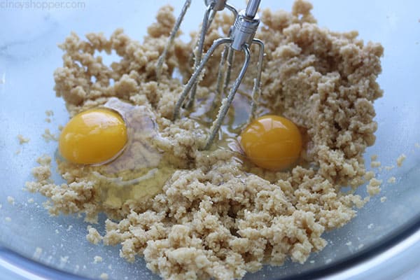 Eggs and sugars added to apple bread mixture.