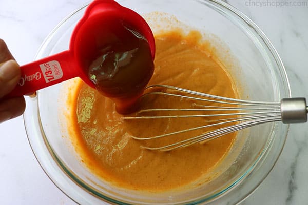 Adding caramel topping to butterscotch pudding.