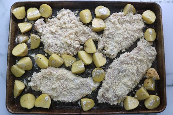 Crusted Ranch Chicken with potatoes on a baking sheet.