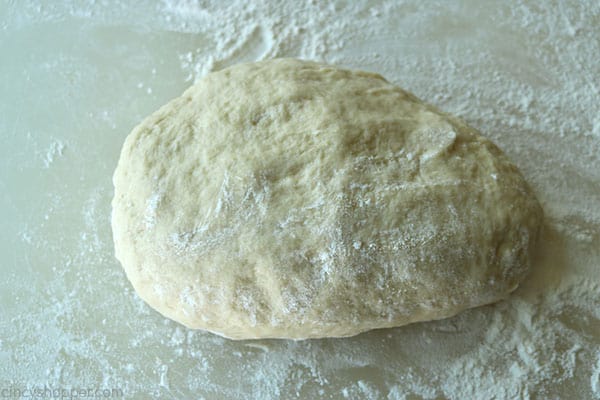 Dinner roll dough on a floured surface.