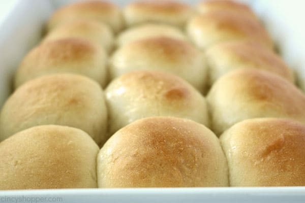 Fresh baked easy dinner rolls in a white pan.