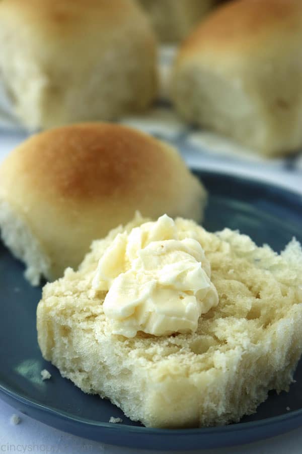 Easy dinner rolls on a plate with butter.