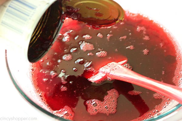 Adding whole berry cranberry sauce to Jello mixture.