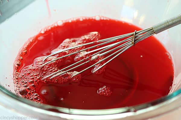 Whisking to dissolve raspberry Jello.