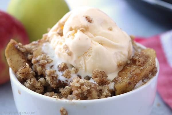 Easy apple crisp topped with ice cream in a bowl.