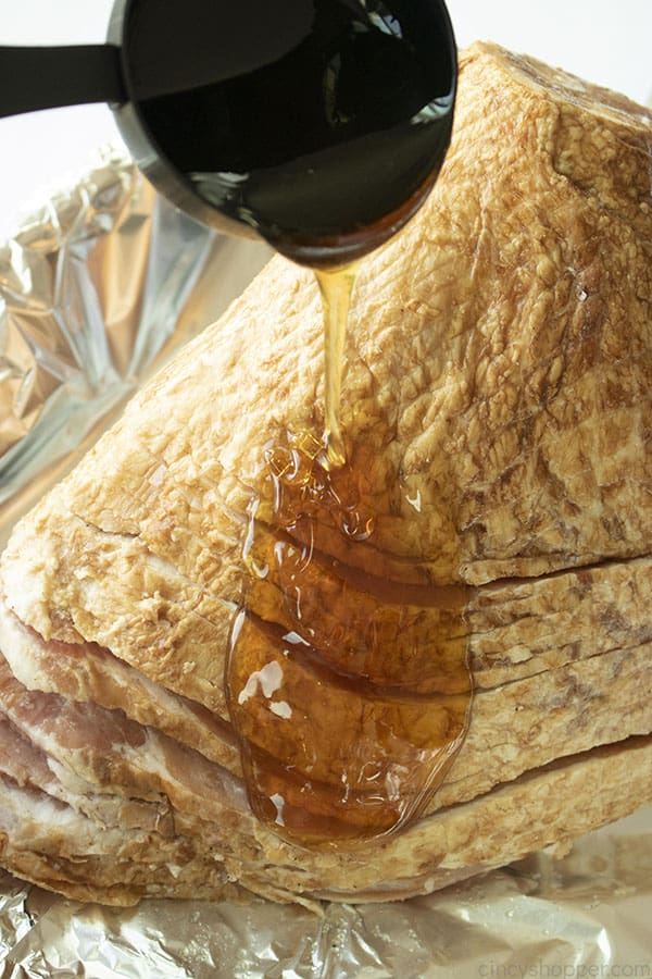 Adding honey to homemade Honey Baked Ham