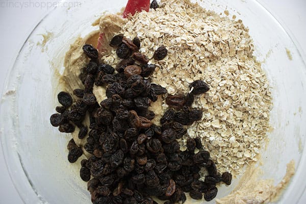 Adding oats and raisins to cookie dough