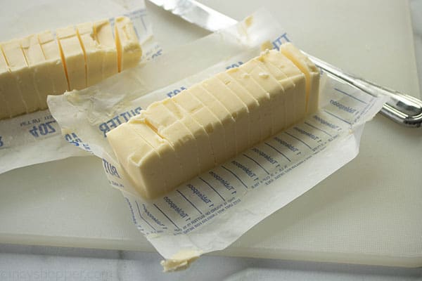 two sticks of butter sliced into pads