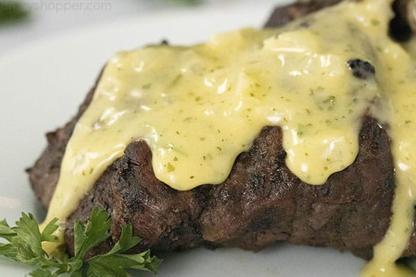 close up of a steak with bearnaise sauce on top