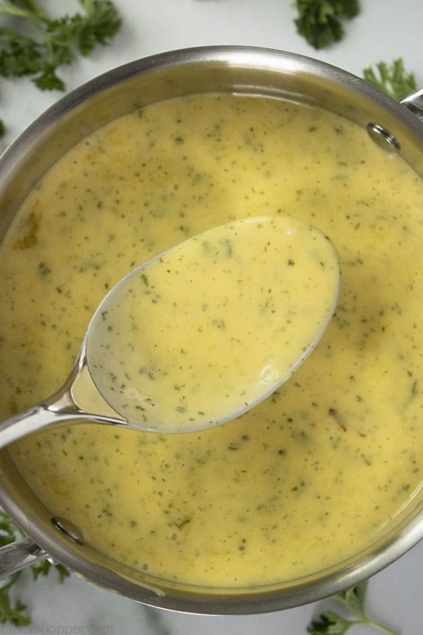 overhead view of bearnaise sauce recipe in a pot with a spoon