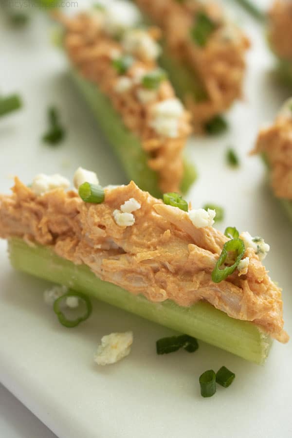 platter of celery sticks with Buffalo chicken topping