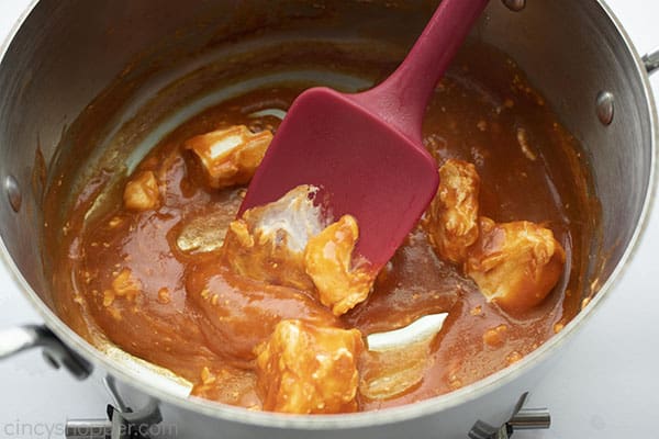 close up of Buffalo sauce and cream cheese melting in a pot