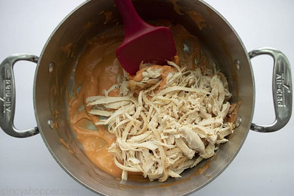 shredded chicken in a pot with Buffalo sauce