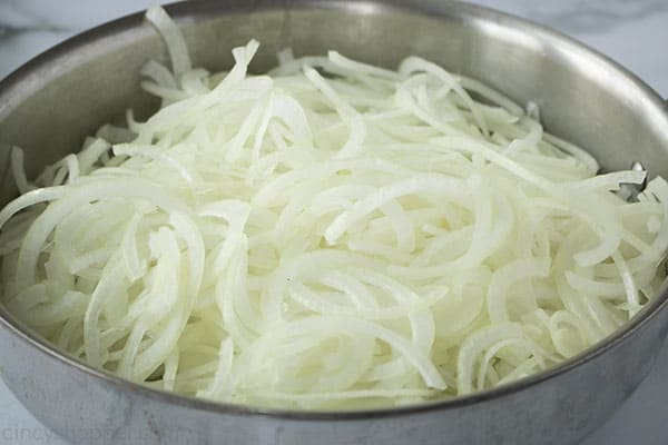 pan full of sliced raw onions