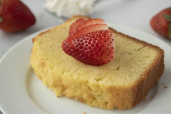 slice of easy pound cake on a plate with strawberries