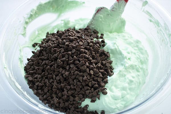Folding in mini chocolate chips to green dip