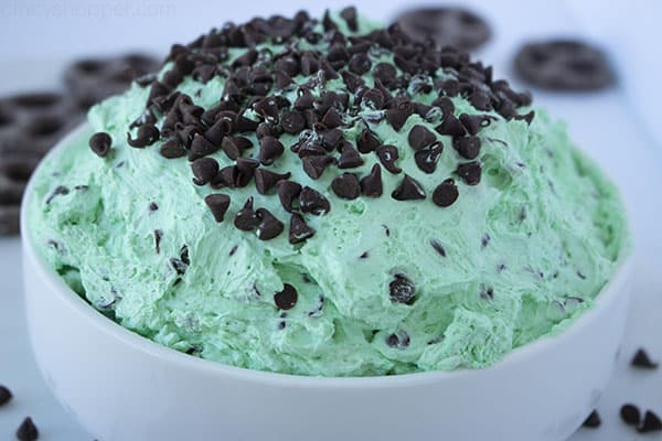 Overflowing bowl of green mint cheesecake dip