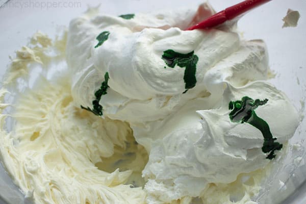 Folding in the whipped topping and food coloring for mint dip