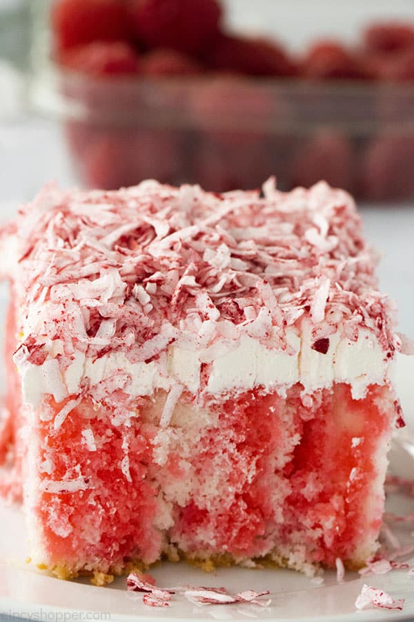 Raspberry Zinger Poke Cake on a white plate