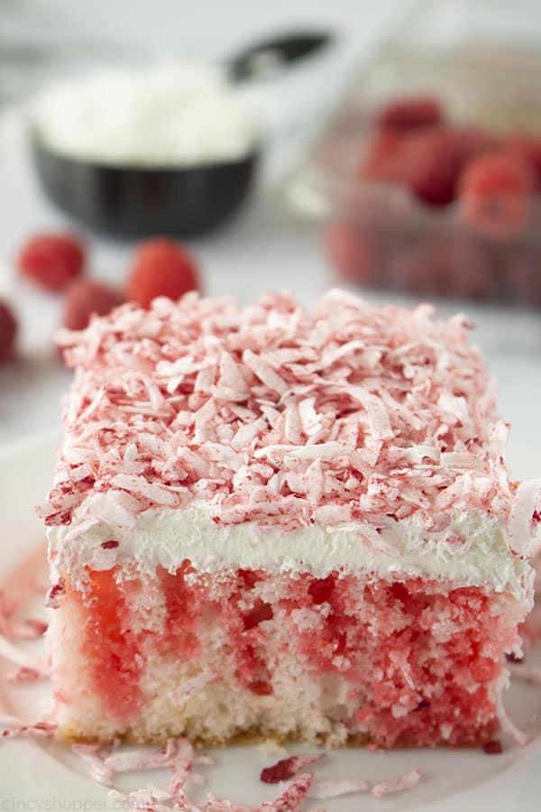 Slice of moist Raspberry cake with coconut on a plate