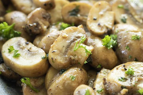 close up of tender, golden brown cooked mushrooms with garlic