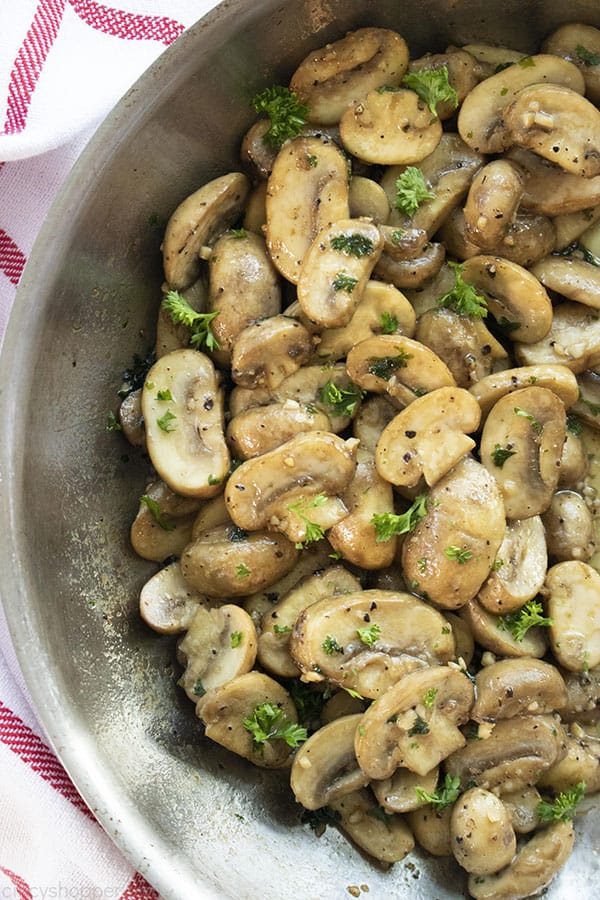 overhead image - button mushrooms cooking in pan