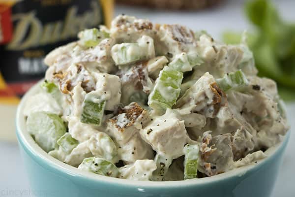 cubes of white meat chicken and celery combined with mayonnaise in a bowl