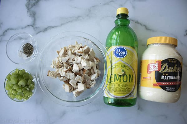 ingredients to make the best chicken salad recipe on marble board