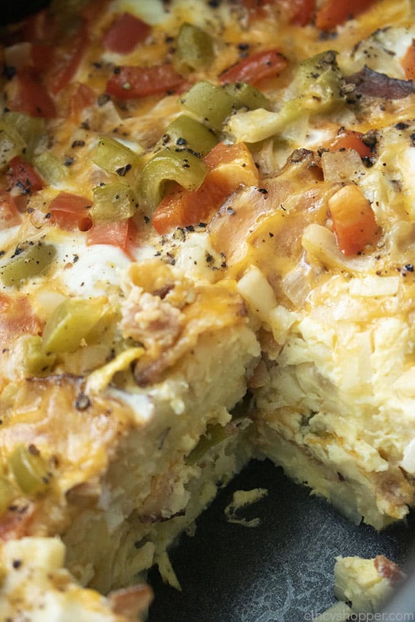 baked casserole with bacon, hashbrowns, veggies and cheese in crockpot