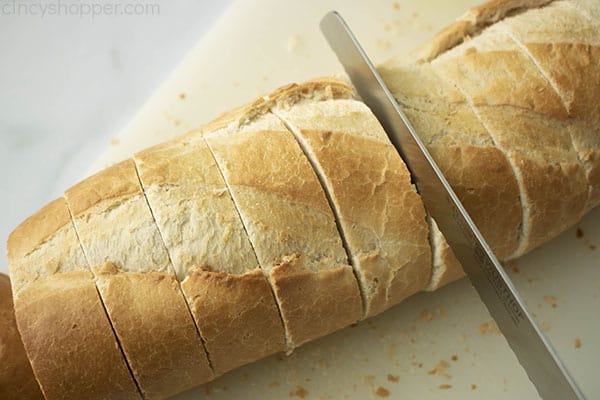 cutting French bread into slices