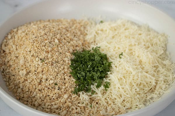 ingredients in bowl for breading chicken - panko, shredded cheese, and parsley