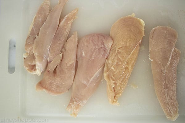 raw chicken breasts on cutting board