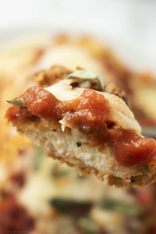 close up of panko coated chicken breast with marinara sauce