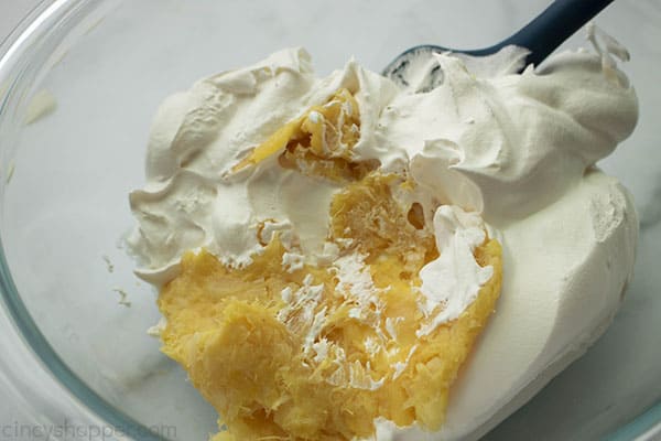 Folding crushed pineapple and Cool-Whip