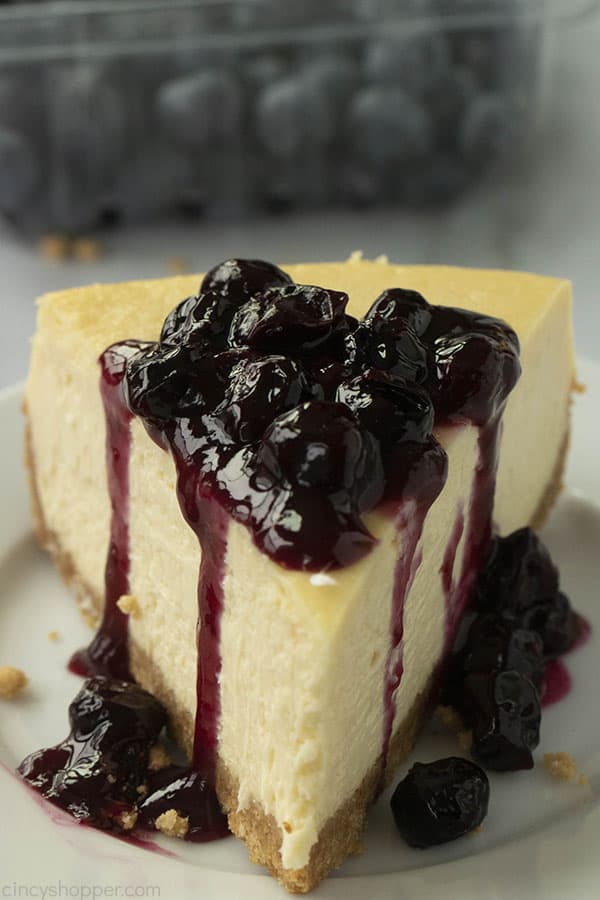 new york style cheesecake topped with blueberry sauce