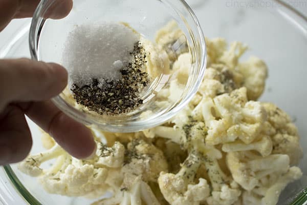 How to make Roasted Cauliflower, step 4: Add the salt and pepper to the florets and toss everything together until well mixed.