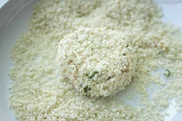 coating salmon patty in bread crumb mixture