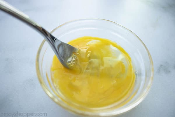 beating egg in bowl with a fork