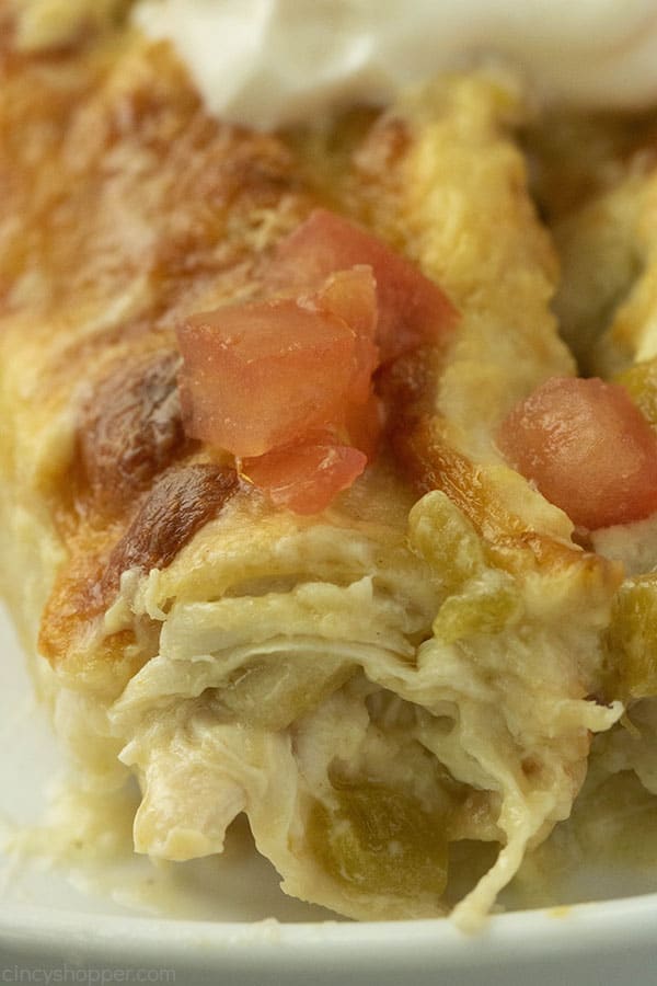 close up image of chicken filling in an enchilada
