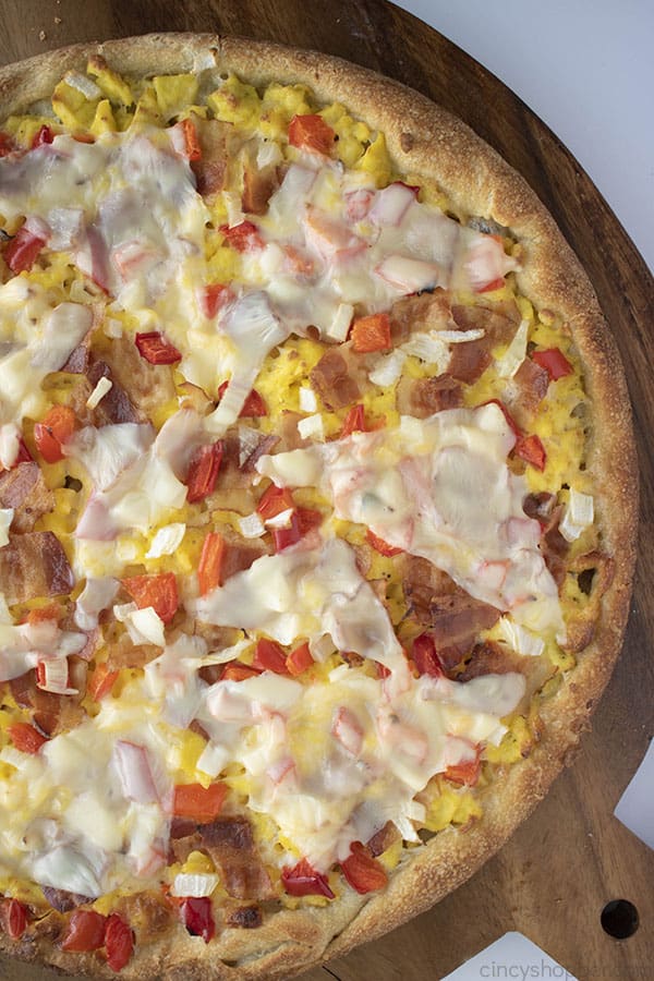 breakfast pizza with bacon, eggs, and cheese