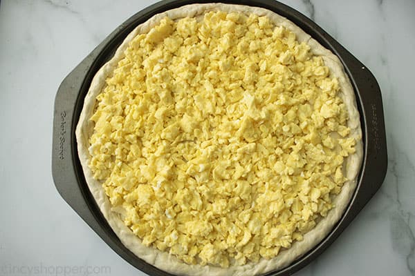 cooked scrambled eggs on pizza crust