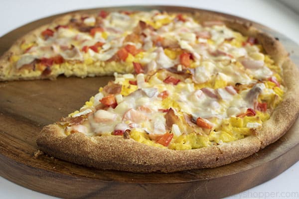 breakfast pizza with a slice removed