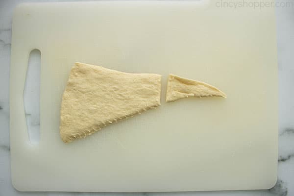 Cut piece of crescent roll dough.