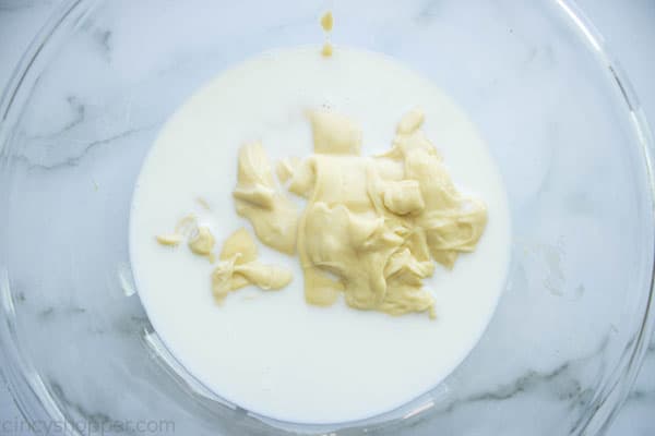 mixing condensed soup with milk in a bowl