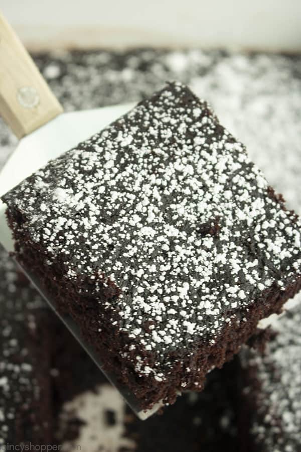square slice of wacky chocolate cake dusted with powdered sugar